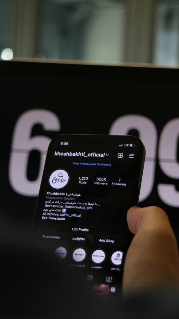 a person holding a smart phone in their hand